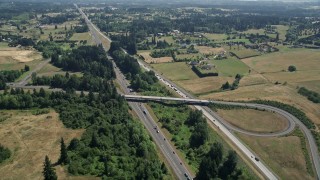 AX52_087E - 5K aerial stock footage approach I-5 with light traffic beside farm fields in Ridgefield, Washington
