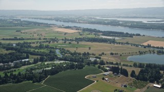 AX52_091 - 5K aerial stock footage approach wide farm fields near the Columbia River in Ridgefield, Washington