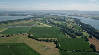 AX52_095 - 5K aerial stock footage flyby farms and green fields near the Columbia River in Vancouver, Washington