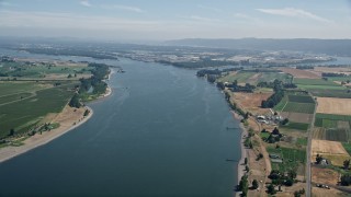 AX52_098E - 5K aerial stock footage of Columbia River between Washington and Riverview, Oregon farmland