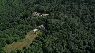 AX52_106 - 5K aerial stock footage of three homes surrounded by forest in the Tualatin Mountains, Oregon