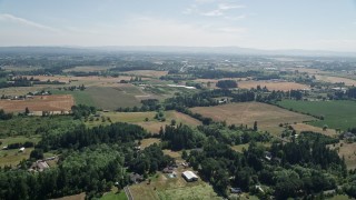 AX52_110 - 5K aerial stock footage of flying over farms and fields in Hillsboro, Oregon