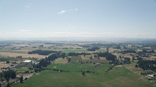 AX52_111 - 5K aerial stock footage pass by large fields and farms in Hillsboro, Oregon