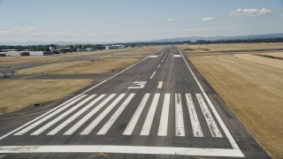AX52_119 - 5K aerial stock footage of flying low by a runway, Hillsboro Airport, Oregon