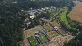 AX53_002 - 5K stock footage aerial video of flying by fields and the Oregon National Primate Research Center, Hillsboro