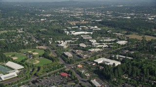 AX53_003 - 5K aerial stock footage of approaching Nike Headquarters among trees, Beaverton, Oregon