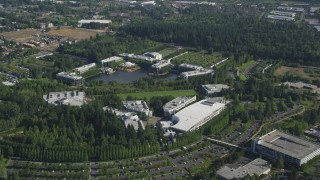 AX53_005 - 5K aerial stock footage of Nike Headquarters beside a lake, Beaverton, Oregon