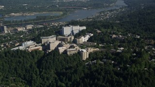AX53_015 - 5K aerial stock footage of Oregon Health and Science University on a tree covered hill, Portland, Oregon