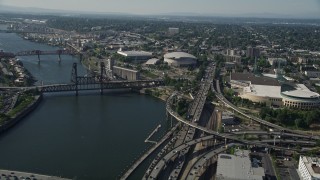 AX53_020E - 5K aerial stock footage of approaching the Moda Center from Willamette River, Lloyd District, Northeast Portland, Oregon