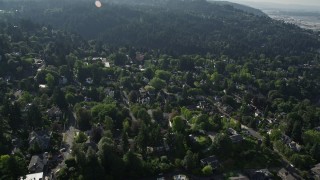 AX53_042 - 5K aerial stock footage fly over tree filled neighborhoods in the hills, Southwest Portland, Oregon
