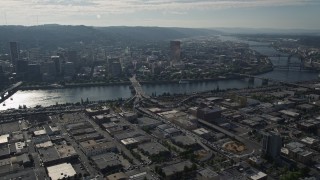 AX53_047 - 5K stock footage aerial video of Downtown Portland cityscape seen from industrial area, Portland, Oregon