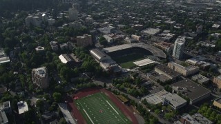 AX53_050 - 5K stock footage aerial video fly by high school football field and Major League soccer field, Providence Park, Downtown Portland, Oregon