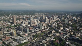 AX53_052E - 5K aerial stock footage fly over city buildings toward skyscrapers, Downtown Portland, Oregon