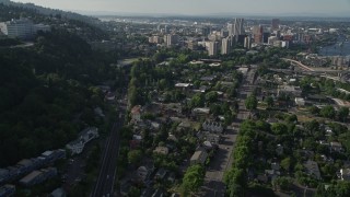 AX53_064 - 5K aerial stock footage of tracking a gondola over homes and city streets, Southwest Portland, Oregon
