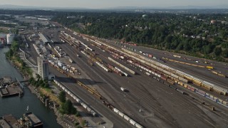 AX53_080 - 5K aerial stock footage of flying by trains at a train yard, North Portland, Oregon