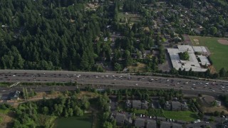 AX53_092 - 5K aerial stock footage fly by heavy highway traffic, a school and park, Southwest Portland, Oregon