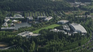 AX53_098 - 5K aerial stock footage fly by Nike Headquarters nestled among trees, Beaverton, Oregon
