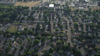 AX53_100 - 5K aerial stock footage tilt to bird's eye of tract homes and tiny condo units, Beaverton, Oregon