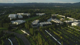 AX54_005 - 5K aerial stock footage of flying by Nike Headquarters in Beaverton, Oregon, sunset
