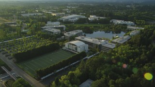 AX54_006 - 5K aerial stock footage of flying by Nike Headquarters, Beaverton, Oregon, sunset