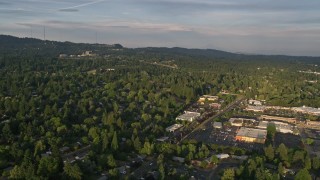AX54_007 - 5K aerial stock footage approach and fly over suburban homes and a shopping center, Beaverton, Oregon, sunset