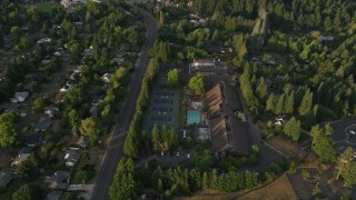 AX54_008 - 5K aerial stock footage of flying over a community sports center in Beaverton, Oregon, sunset