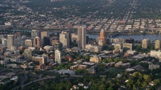 AX54_018 - 5K aerial stock footage of flying by downtown buildings, Downtown Portland, Oregon, sunset