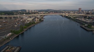 AX54_028E - 5K aerial stock footage fly over Willamette River, Fremont Bridge, pan to Downtown Portland, Oregon, sunset