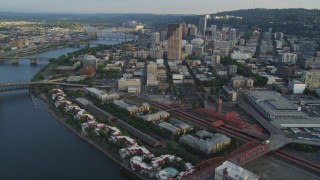 AX54_029 - 5K aerial stock footage of approaching Downtown Portland, flying by Union Station, Portland, Oregon, sunset