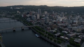 AX54_031 - 5K aerial stock footage of flying by downtown, Morrison Bridge, Downtown Portland, Oregon, sunset
