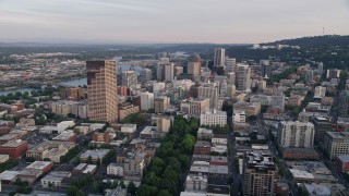 AX54_048E - 5K aerial stock footage of approaching Oregon Science and Health University from Downtown Portland, Oregon, sunset