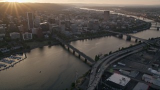 AX54_057E - 5K aerial stock footage follow Hawthorne Bridge, Willamette River, Downtown Portland, Oregon, sunset