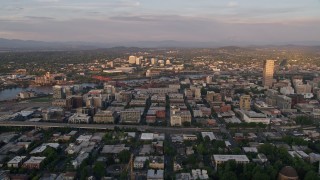 AX54_060 - 5K aerial stock footage of a view of downtown buildings, Lloyd District and the Willamette River at sunset, Downtown Portland, Oregon