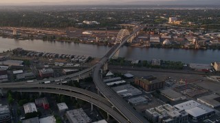 AX54_061 - 5K aerial stock footage of approaching Fremont Bridge and freeway interchange, Downtown Portland, Oregon, sunset