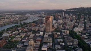AX54_068E - 5K aerial stock footage of approaching US Bancorp Tower and bridges over the Willamette River, Downtown Portland, Oregon, sunset
