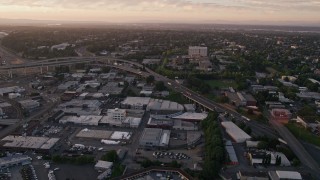 AX54_073 - 5K aerial stock footage of Highway 30 / Interstate 5 interchange and warehouse buildings, North Portland, Oregon, sunset