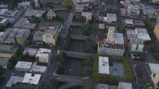 AX54_081 - 5K stock footage aerial video of bird's eye view of following Interstate 405, Downtown Portland, Oregon, sunset