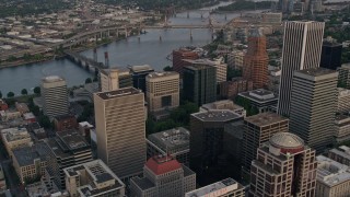 AX54_088 - 5K aerial stock footage of approaching office building and Terry Schrunk Plaza and tilt down Downtown Portland, Oregon, sunset