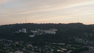 AX54_089 - 5K aerial stock footage of approaching Oregon Health and Science University, Portland, Oregon, sunset