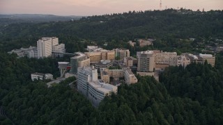 AX54_093 - 5K aerial stock footage of flying away from Oregon Health and Science University, Portland, Oregon, twilight