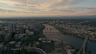 AX54_095E - 5K aerial stock footage of following the Willamette River over bridges, Downtown Portland, Oregon, twilight