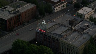 AX54_098 - 5K aerial stock footage of tracking the White Stag Sign, Portland, Oregon, twilight