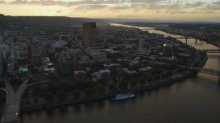 AX54_105 - 5K stock footage aerial video of US Bancorp Tower and Willamette River bridges, Downtown Portland, Oregon, sunset