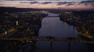 AX55_004E - 5K aerial stock footage of flying by the Fremont Bridge, Downtown Portland, Oregon, twilight
