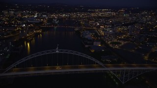 AX55_007E - 5K aerial stock footage of orbiting the Fremont Bridge, revealing Downtown Portland, Oregon, twilight