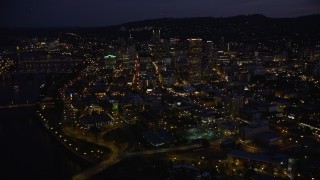 AX55_009E - 5K aerial stock footage flyby skyscrapers in downtown, Steel and Burnside Street Bridges, Downtown Portland, Oregon, twilight