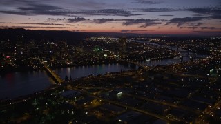 AX55_016E - 5K aerial stock footage of downtown skyscrapers, Morrison Bridge, Burnside Street Bridge, Downtown Portland, Oregon, twilight