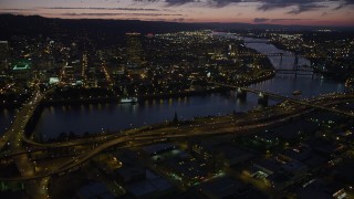 AX55_017 - 5K stock footage aerial video of downtown skyscrapers, Morrison Bridge, Burnside Street Bridge, Downtown Portland, Oregon, twilight