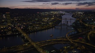 AX55_018 - 5K stock footage aerial video of US Bancorp Tower and bridges along the Willamette River, Downtown Portland, Oregon, twilight