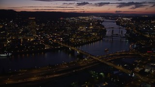 AX55_018E - 5K aerial stock footage of US Bancorp Tower and bridges along the Willamette River, Downtown Portland, Oregon, twilight